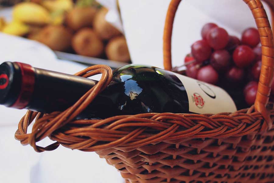 Bottle of red wine in a basket